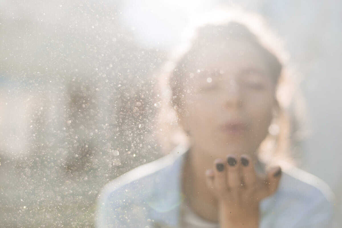 artist blowing particles scaled